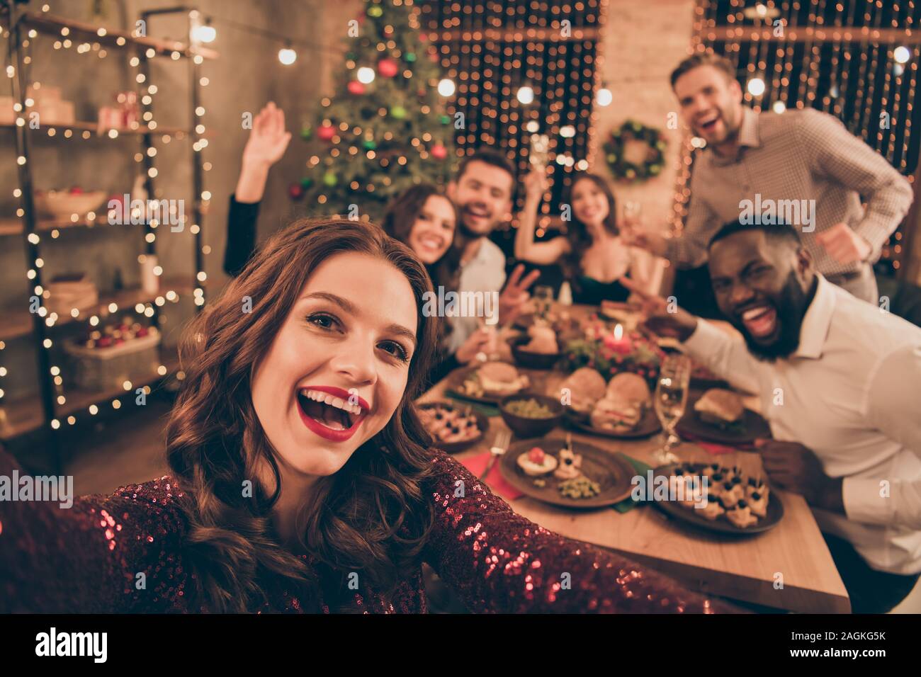 Close up photo of cheerful fellows in formal wear sit around table enjoy christmas party x mas holidays making selfie in house full of noel decoration Stock Photo Alamy