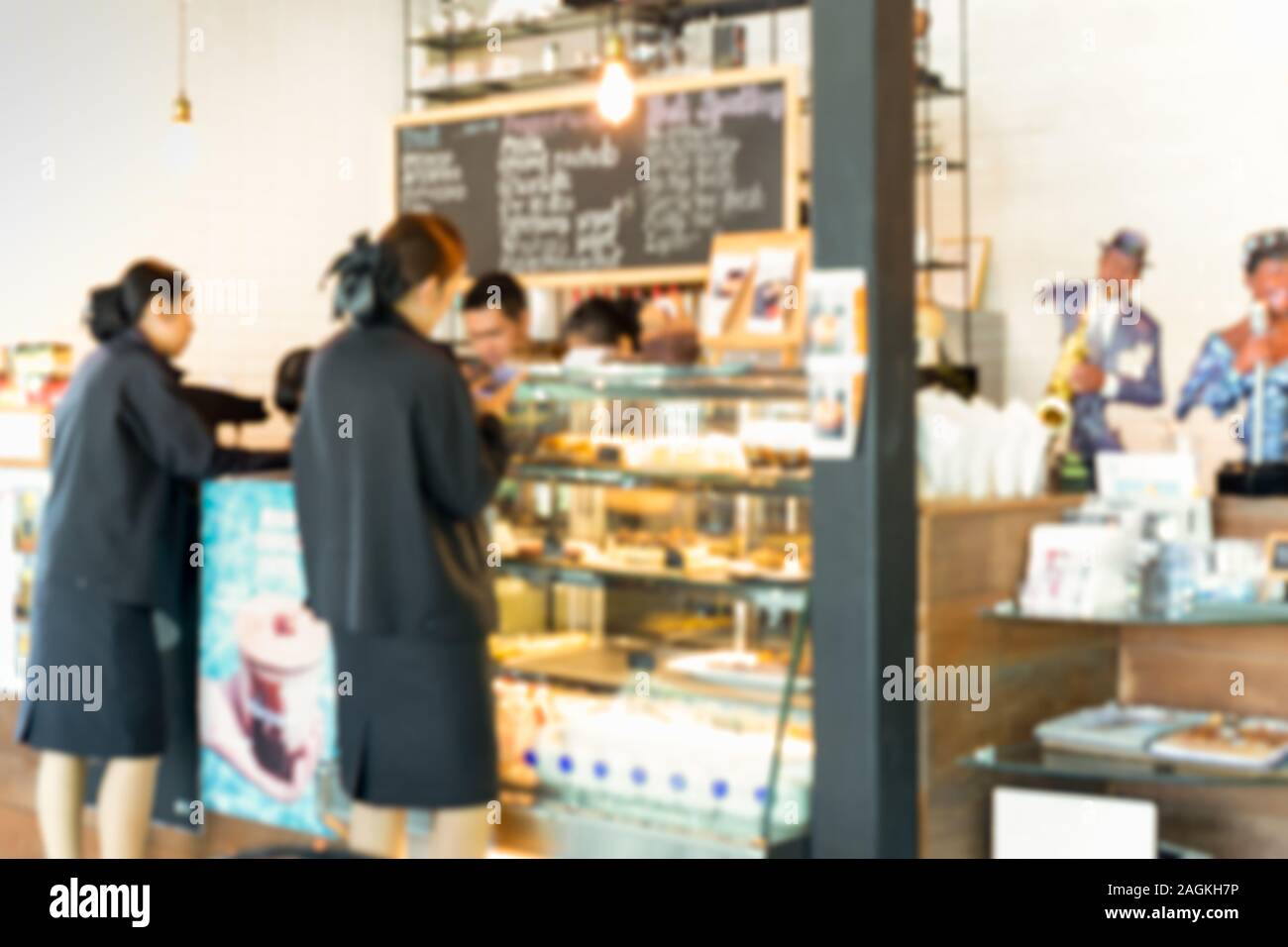 Blurred background barista service customers at counter in coffee shop business concept. Stock Photo
