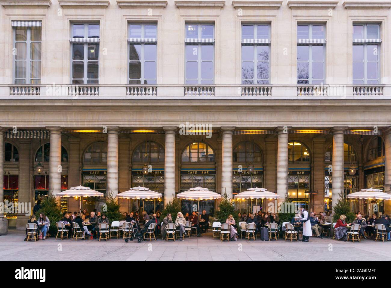 Paris Le Nemours - patrons having drinks at Le Nemours cafe bar in Place Colette in the 1st arrondissement of Paris, France, Europe. Stock Photo