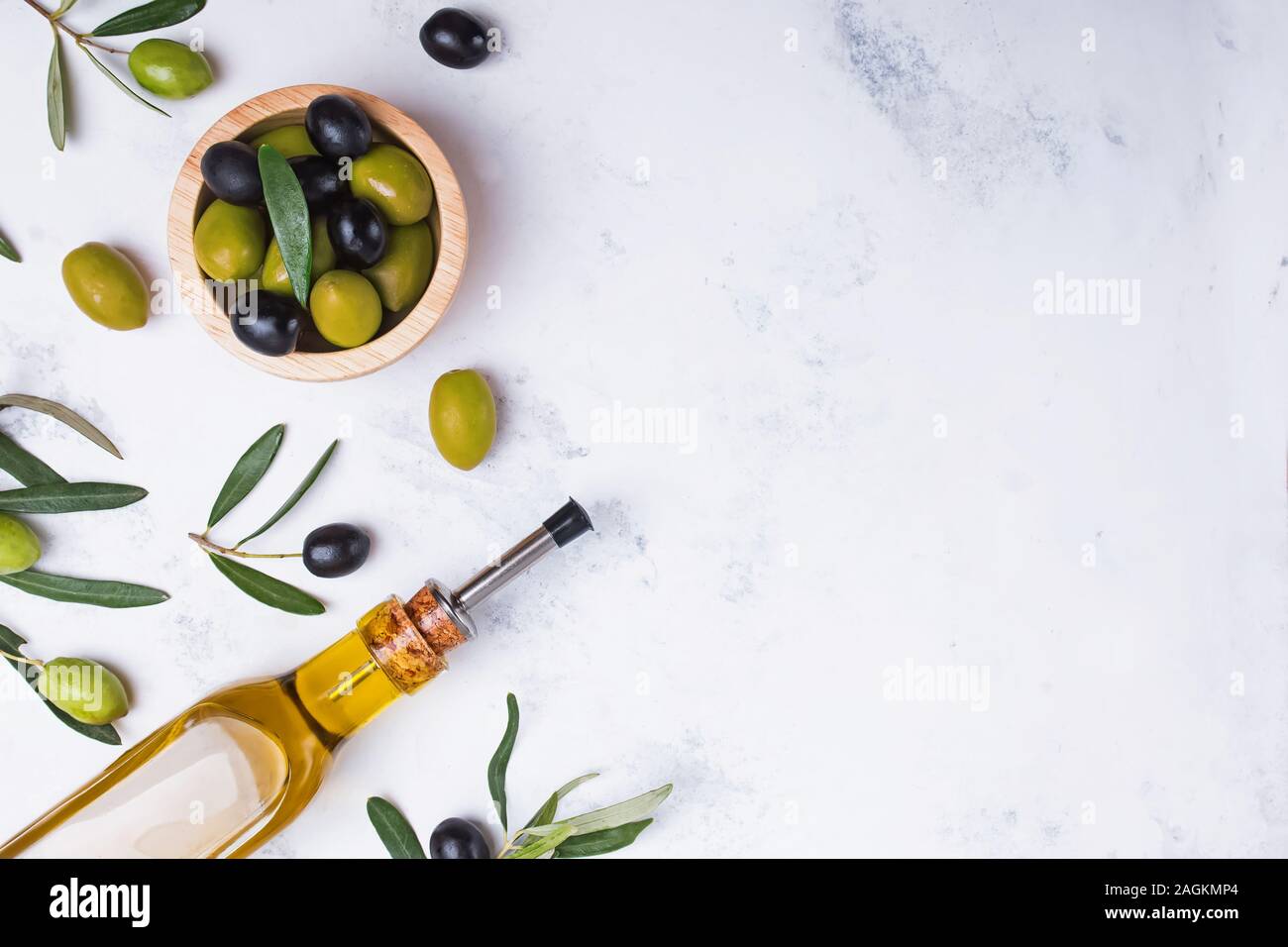 Glass bottle with extra virgin olive oil, fresh and matinated olives ...