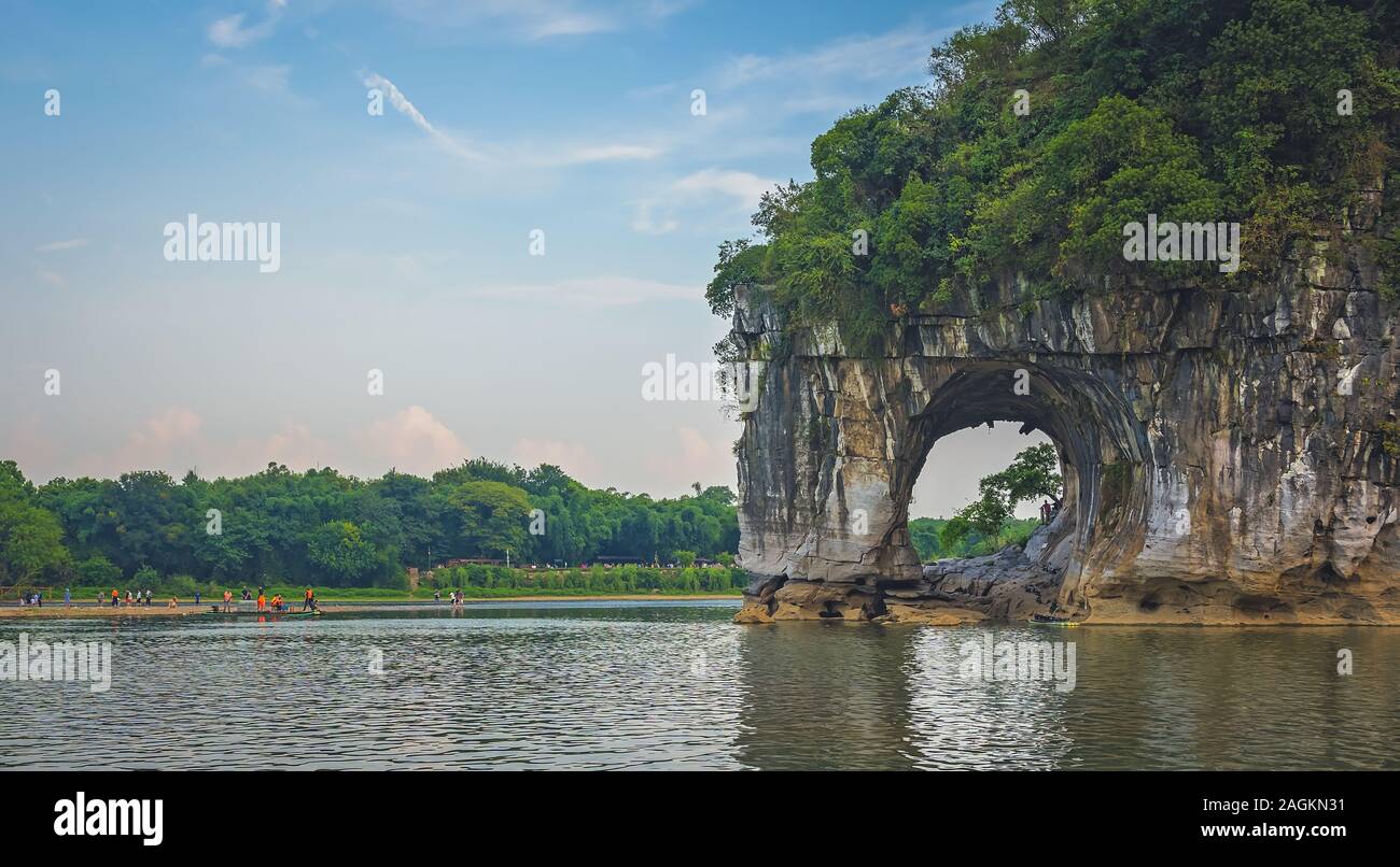 Guilin, China - August 2019 : Tourists in water next to the landmark Elephant Trunk Hill Arch and the Li River Lijiang River, Guangxi Province Stock Photo
