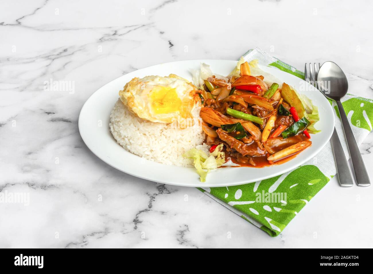 Stirfried Paprika rice with sunny sideup egg. Asia Food on table