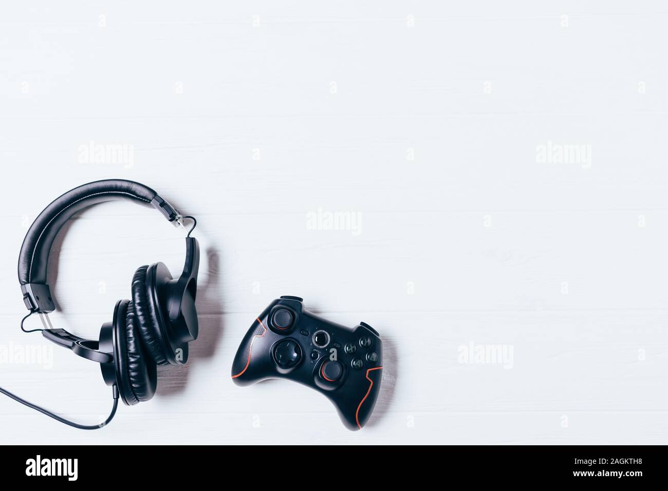 Top view gamepad and headphones on white background with copy space ...