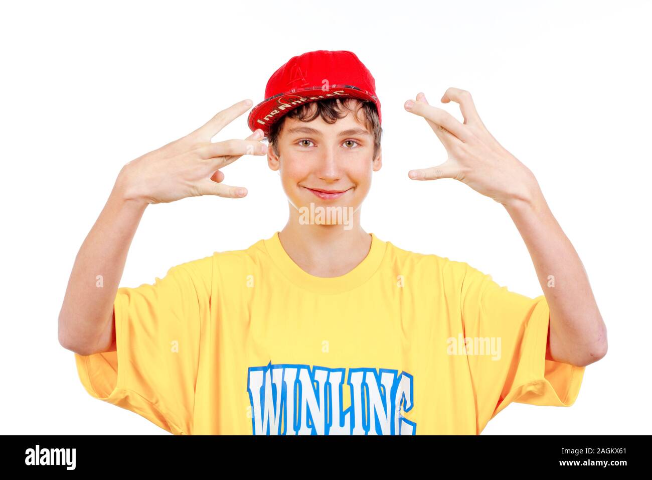 teenage boy in red baseball cap making gestures -isolated on white Stock Photo