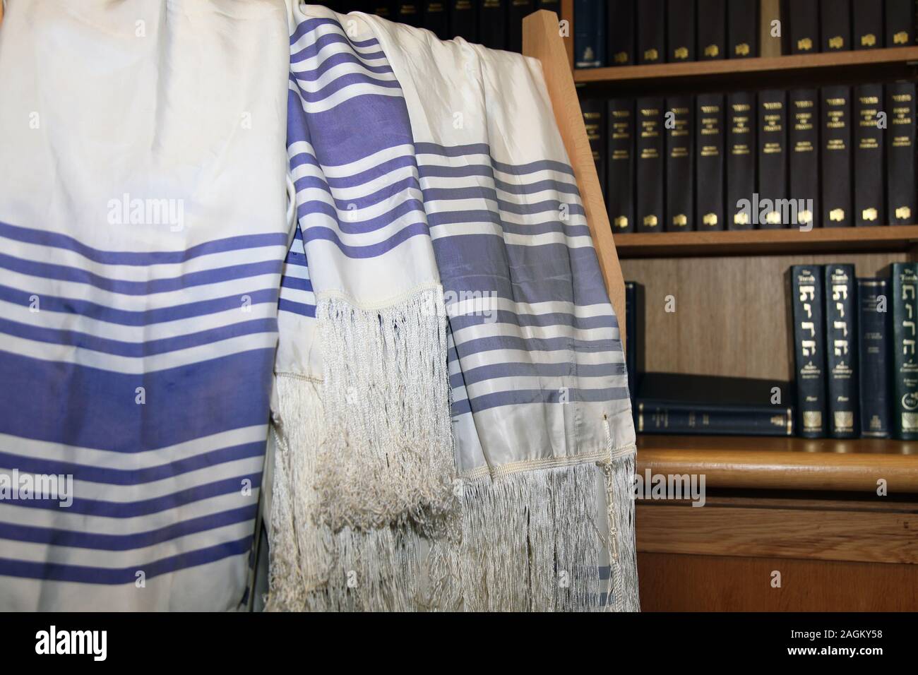 A rack of Jewish Tallit prayer shawls hang at the entrance of a Synagogue Stock Photo