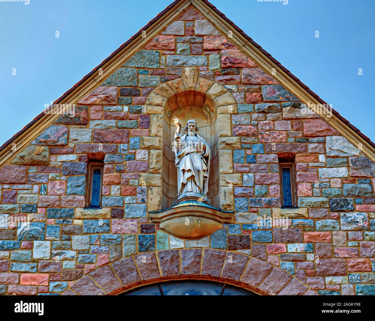 A statue of St. Thomas the Apostle overlooking the entrance of the catholic church at 530 Elizabeth Street Ann Arbor, Michigan. Stock Photo