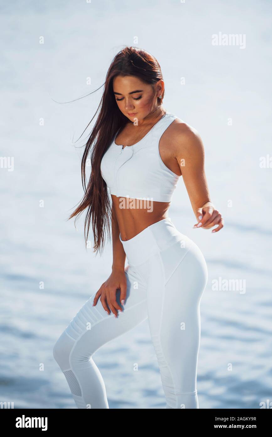 Posing for the camera. Young fitness woman with slim body type is outdoors  Stock Photo - Alamy