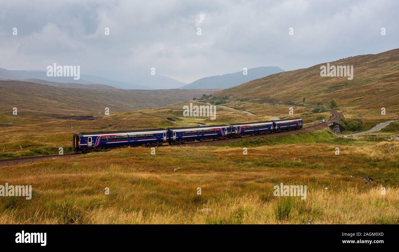 Corrour, Scotland, UK - September 26, 2017: A pair of Scotrail Class 156 'Sprinter' passenger trains climb from Fort William onto the wetland peat bog Stock Photo