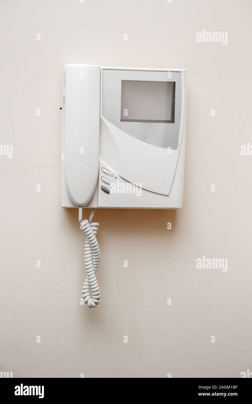 white intercom with screen on beige wall Stock Photo - Alamy
