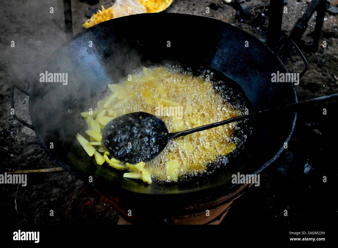 Tradittional method of frying chips to serve as street food. Photo