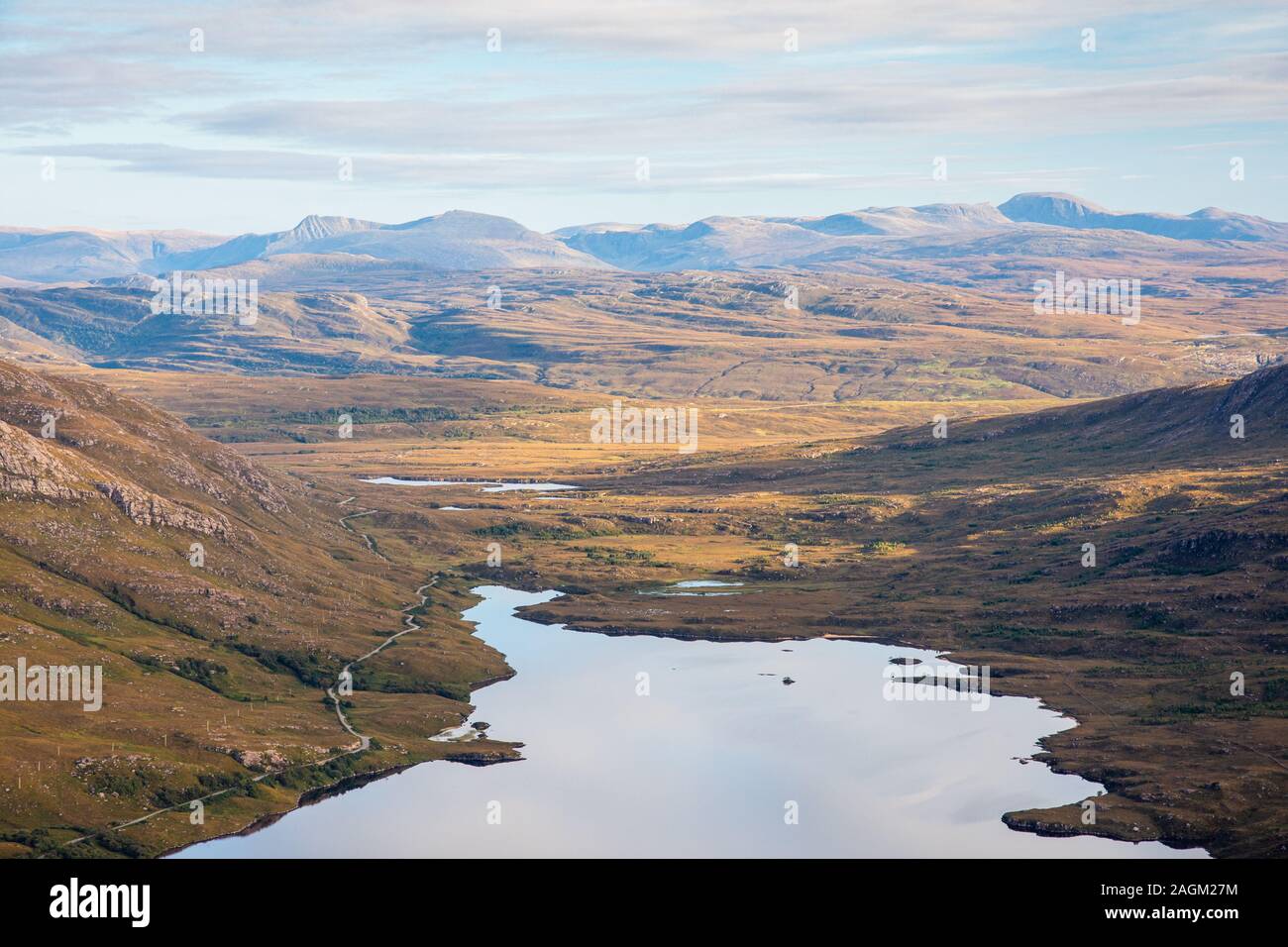 Mountains of Sutherland and Wester Ross rise from the moorland of Coigach and Loch Lurgainn as viewed from Stac Pollaidh mountain in the Highlands of Stock Photo