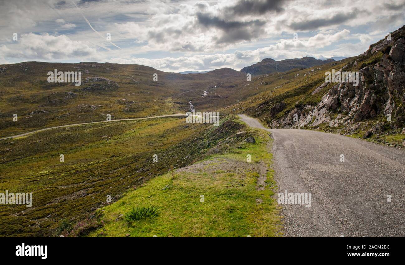 A single-track country road winds across moorland on the Applecross Peninsula in the west Highlands of Scotland. Stock Photo