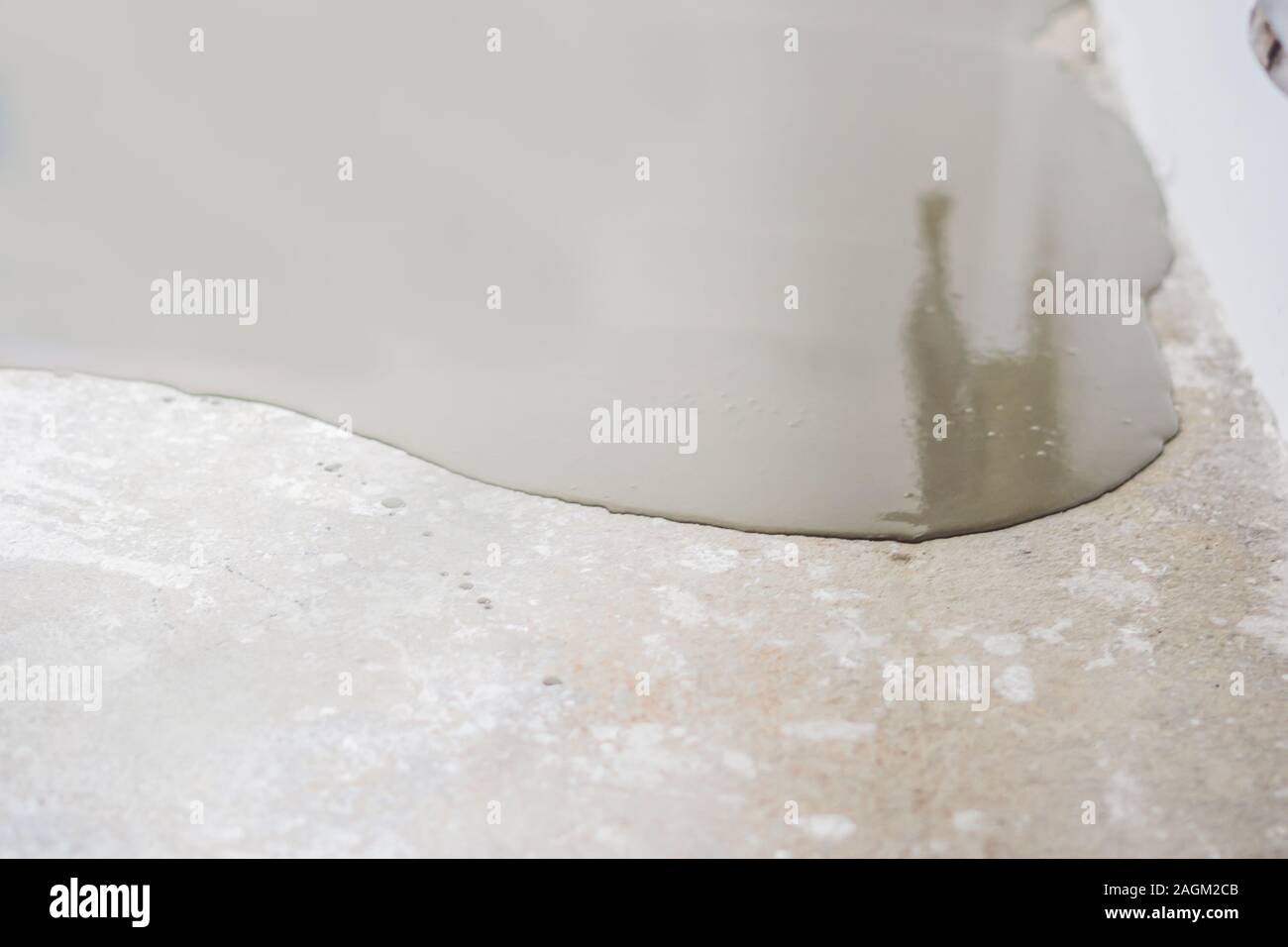 Plasterer During Floor Covering Works With Self Levelling Cement