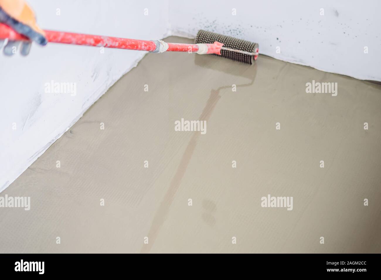 Plasterer During Floor Covering Works With Self Levelling Cement