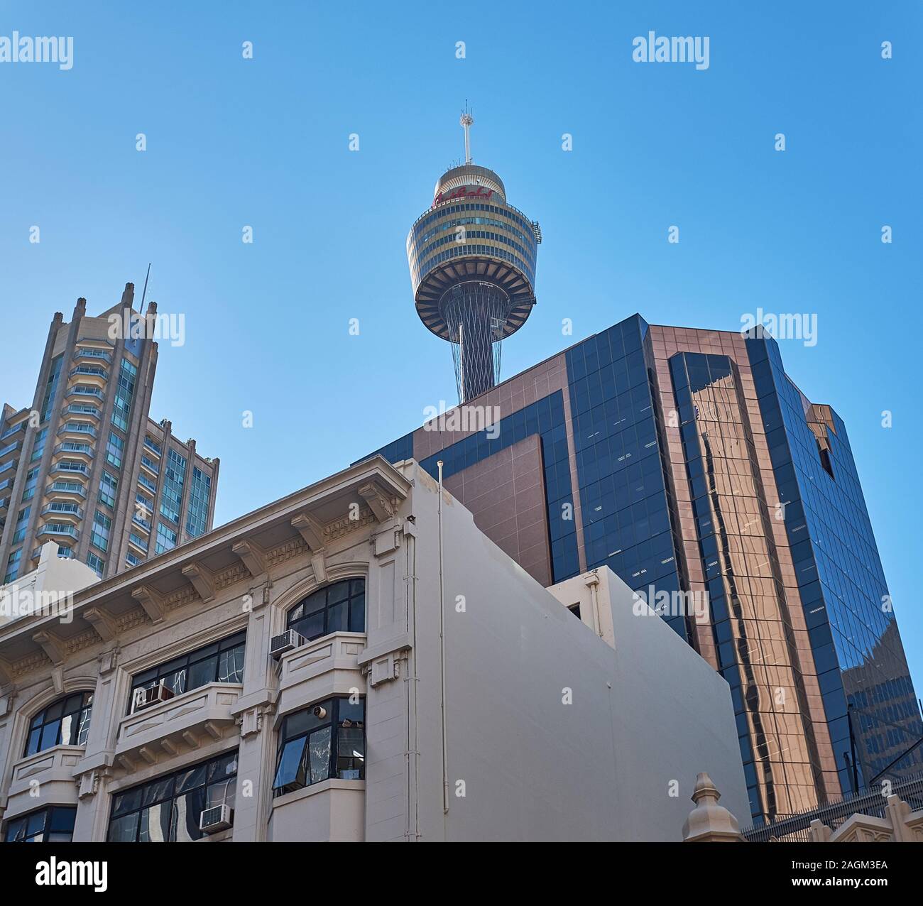 Looking up towards the sky from a street in the Sydney Central Business District with the Sydney Tower rising above the buildings that surrounds it Stock Photo