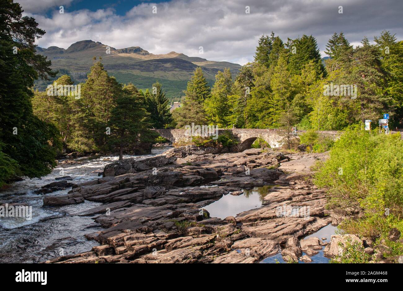 The River Dochart tumbles over the Falls of Dochart above the village of Killin in the Perthshire Highlands of Scotland. Stock Photo