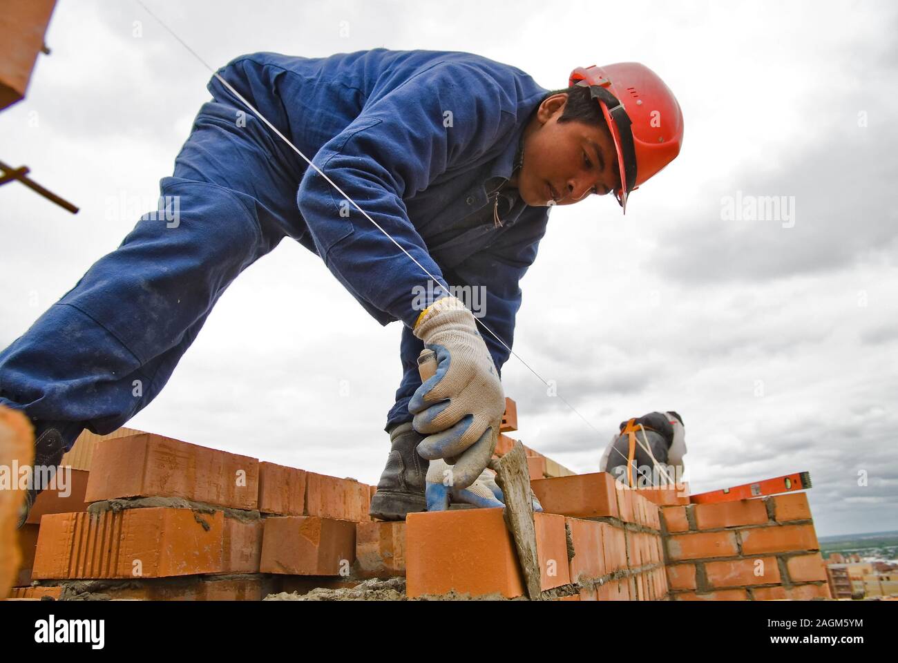 Bricklayer on house construction Stock Photo