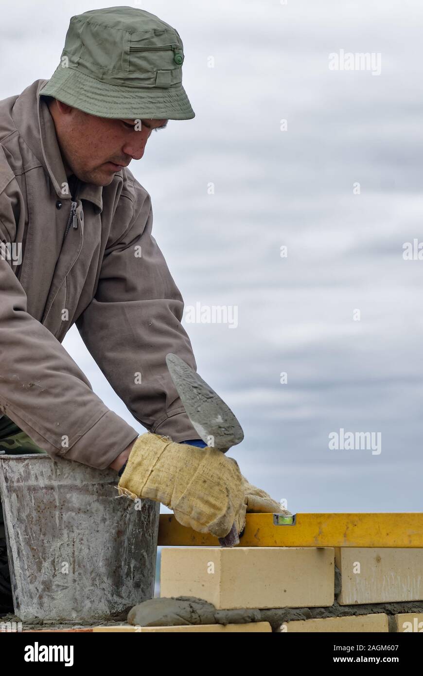Construction mason worker bricklayer with trowel Stock Photo