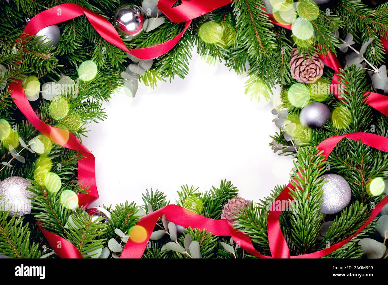 Frame made of Christmas tree branches on a white background with a ...