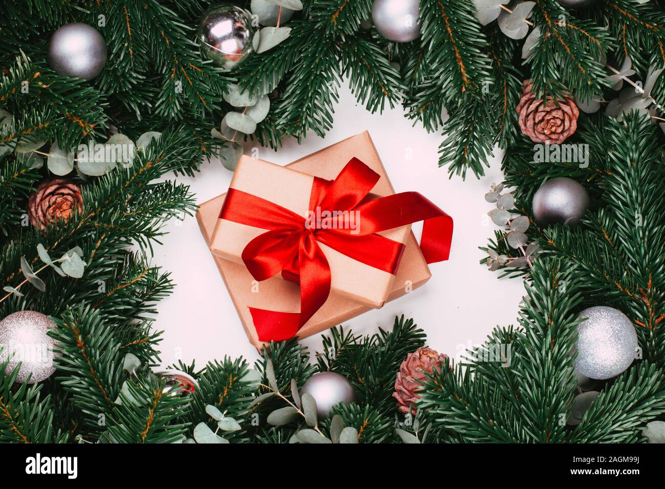 Gifts with red ribbon and branches of the pine tree with Christmas ball ...