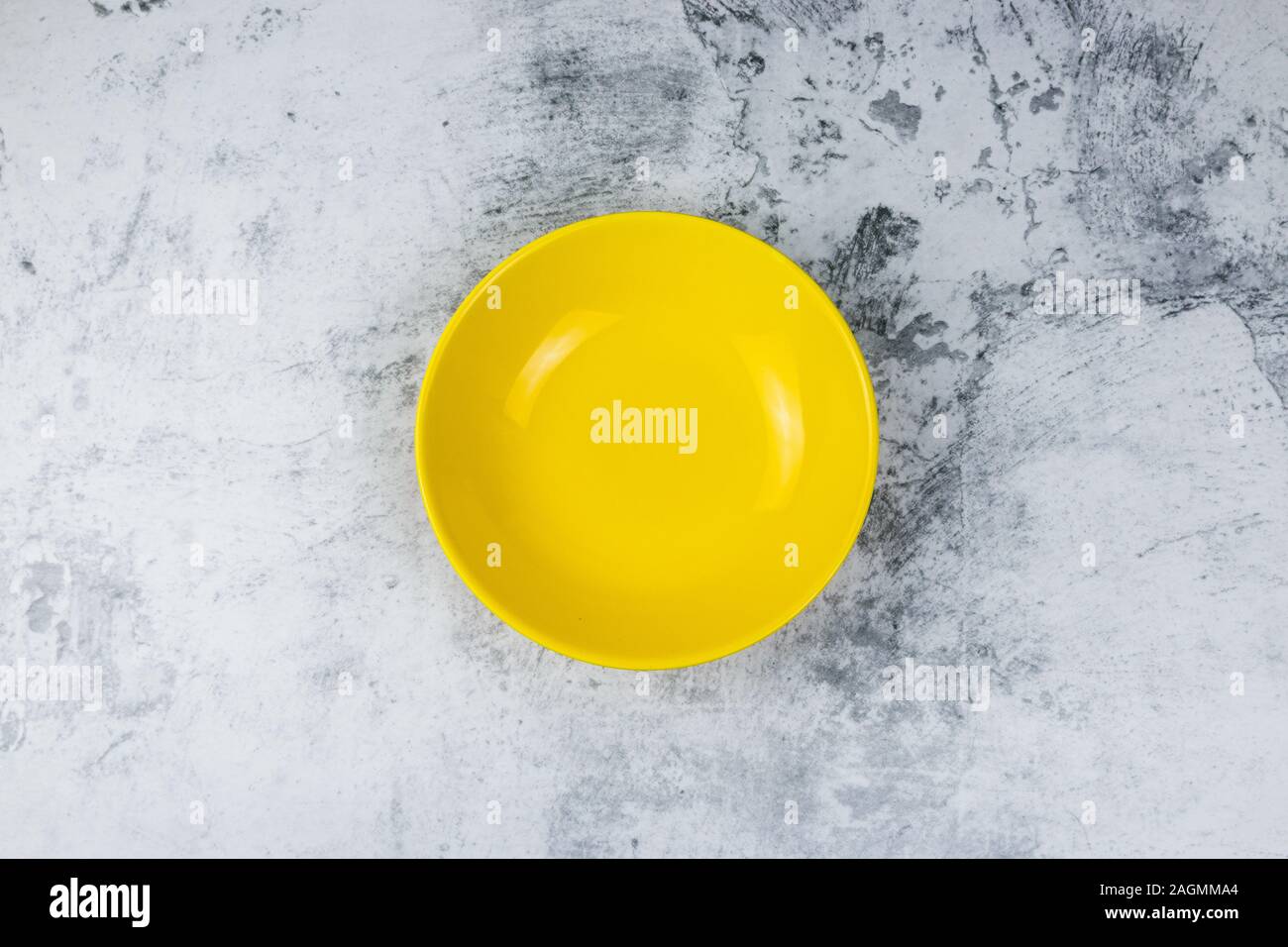 empty yellow bowl on concrete table background. Stock Photo