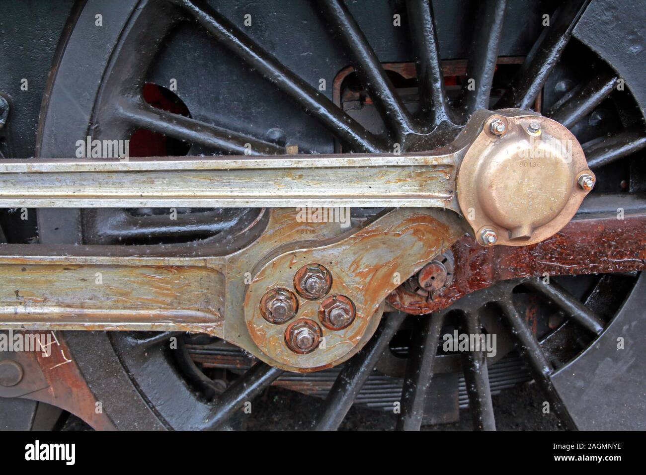 Close up of Steam Engine greased large driving wheel links Stock Photo