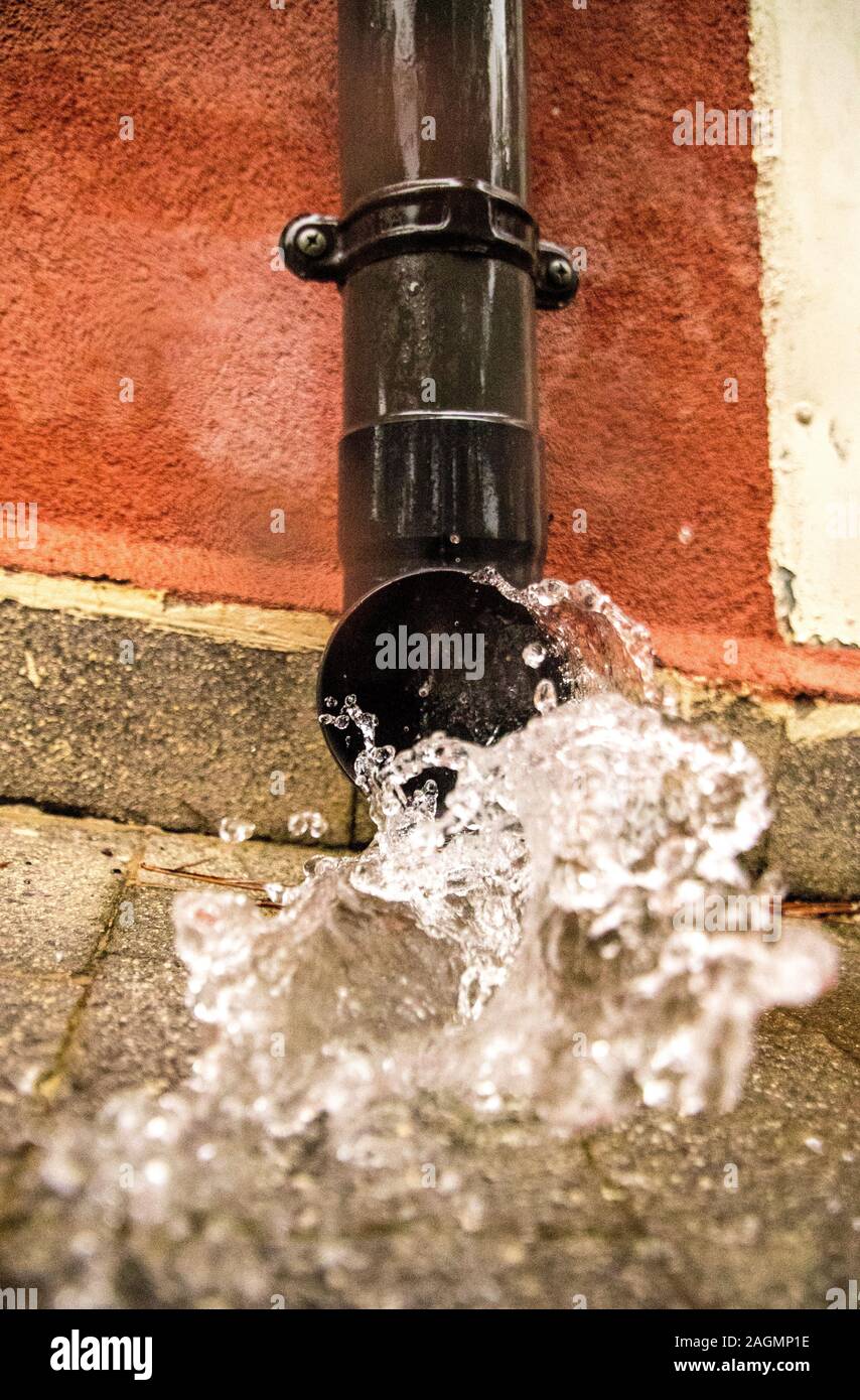 Gutters gush with water from a heavy downpour of rain Stock Photo - Alamy