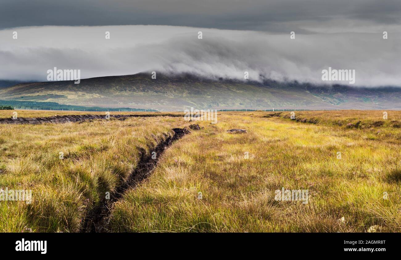 View across cut bog near Ballycroy, County Mayo, Ireland, towards the Nephin Beg mountain range with a covering of mist Stock Photo