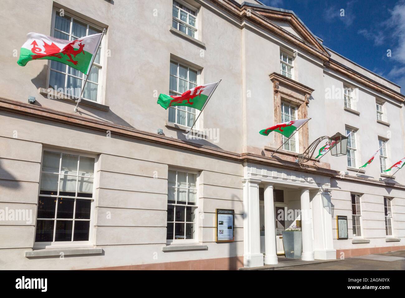 The Welsh flag flies in numbers on the Angel Hotel in Cross Street, Abergavenny, Monmouthshire, Wales, UK Stock Photo