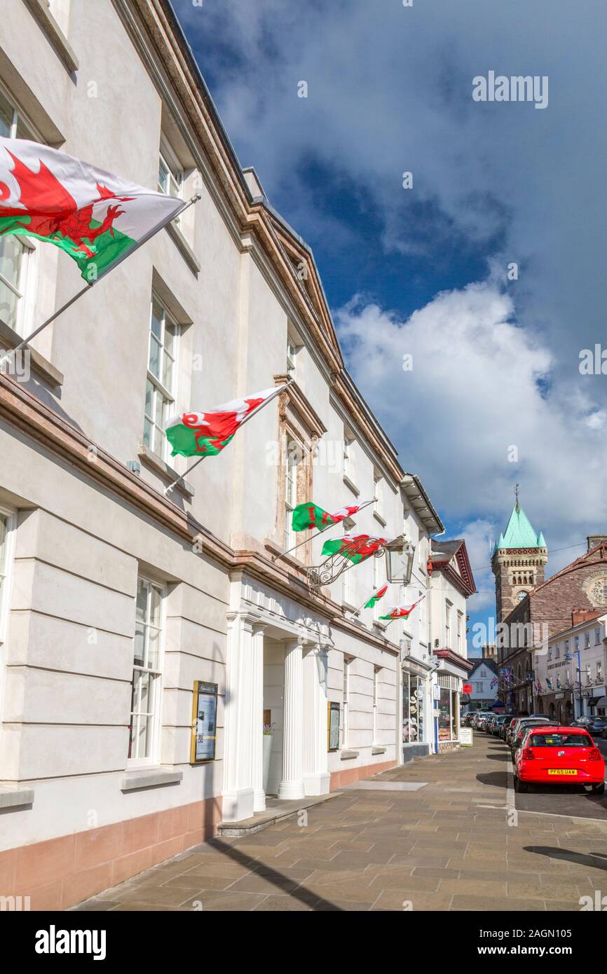 The Welsh flag flies in numbers on the Angel Hotel in Cross Street, Abergavenny, Monmouthshire, Wales, UK Stock Photo