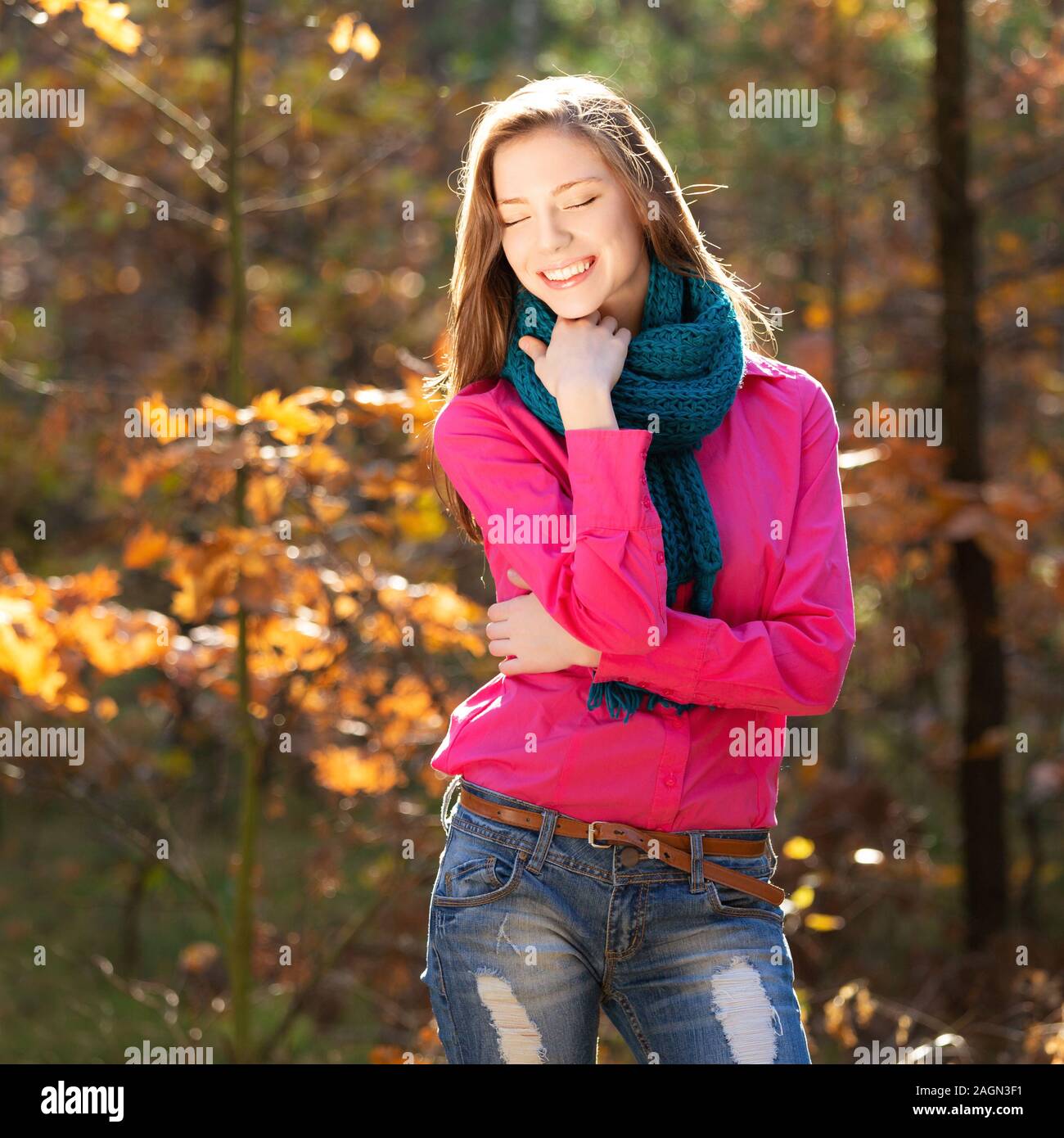 Smiling young girl in the autumn park Stock Photo
