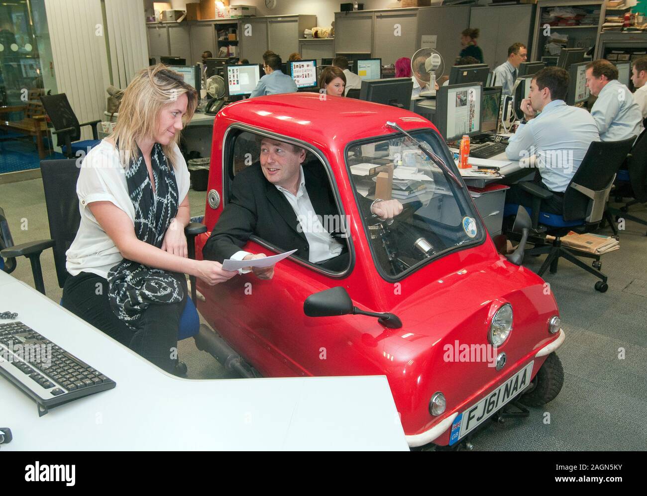 A Peel P50 the smallest car in the world is road tested around the streets and offices of Kensington. Stock Photo