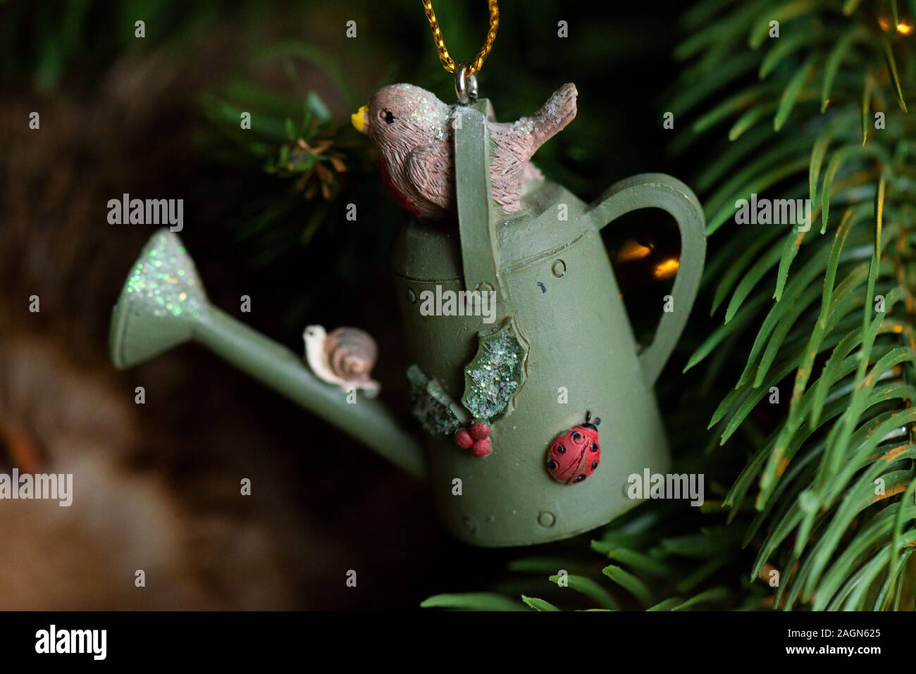 A robin on a watering can hanging Christmas tree decoration Stock Photo