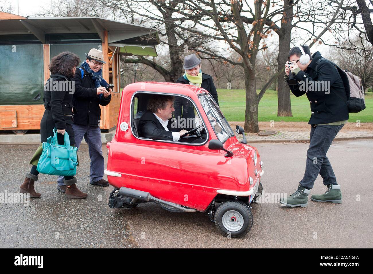A Peel P50 the smallest car in the world is road tested around the streets and offices of Kensington. Stock Photo