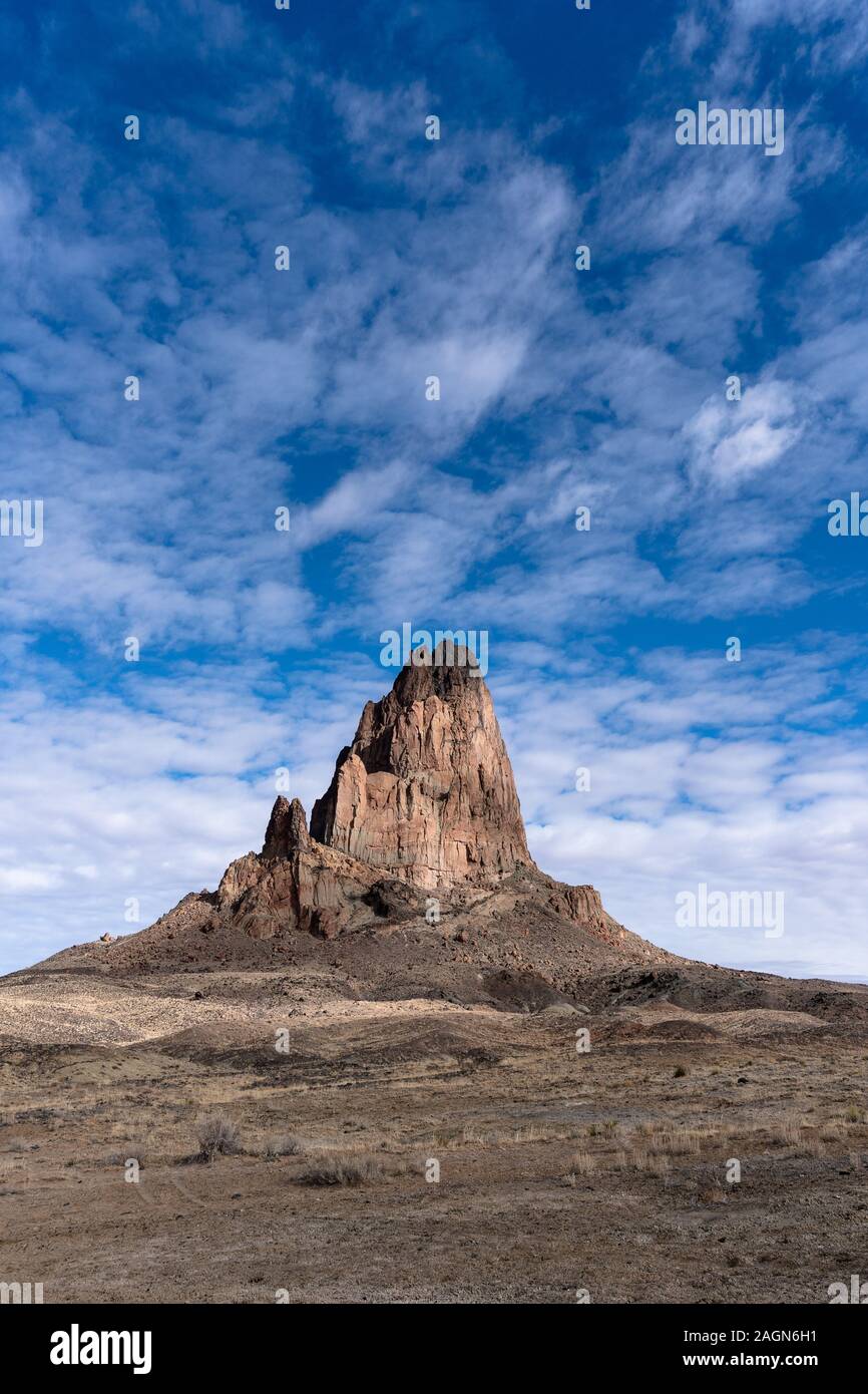 Agathla Peak stands prominently in the southwestern desert landscape near Monument Valley, Arizona, USA Stock Photo