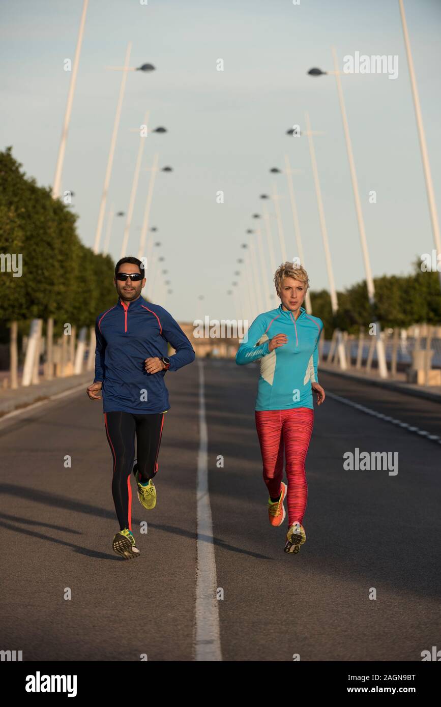 Young couple jogging, Alicante, Spain Stock Photo