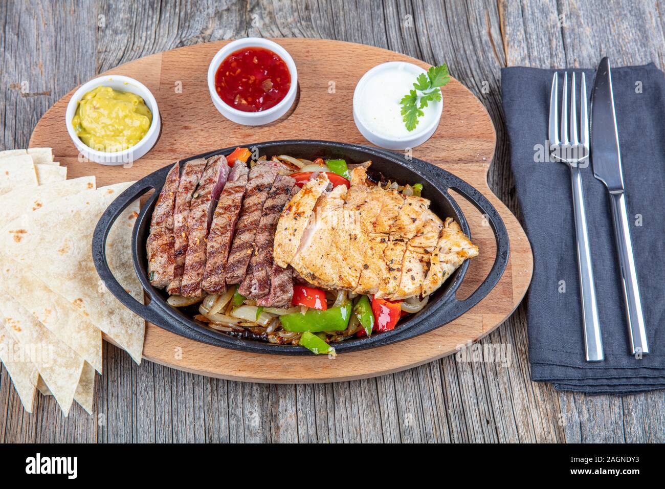 Combo Fajita; mexican steak and chicken fajitas in iron skillet with