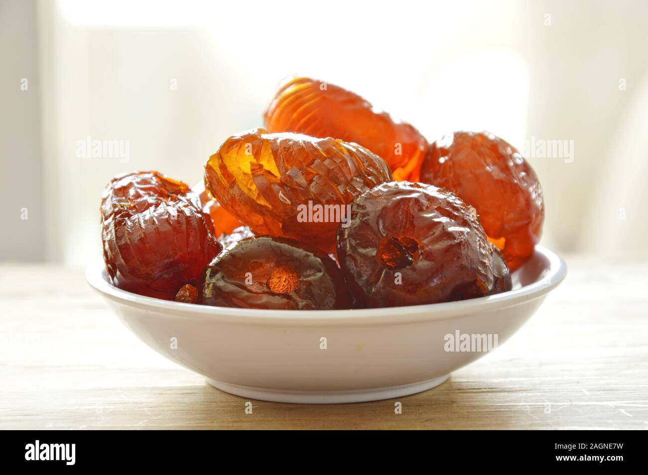 Chinese jujube candy coating syrup on little cup Stock Photo - Alamy