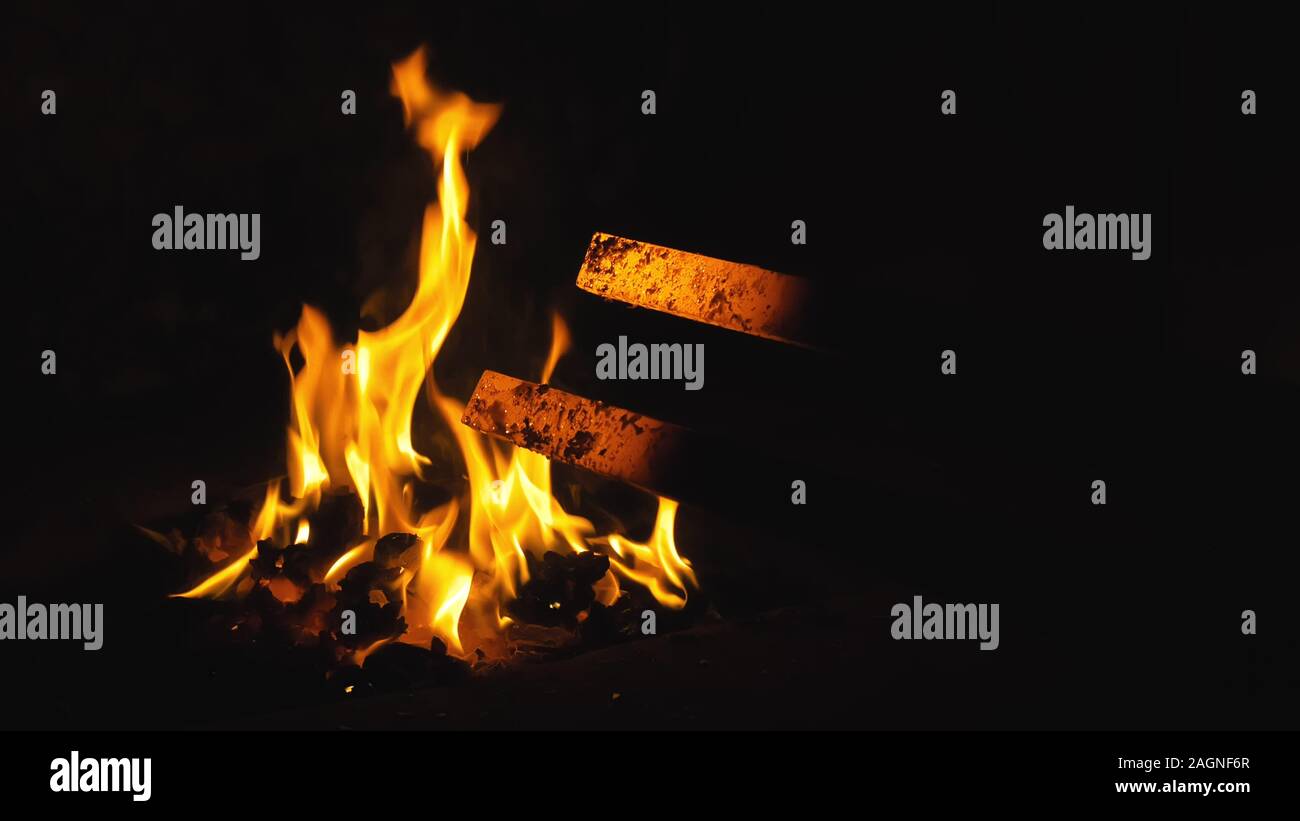 fire in furnace. Blacksmith tempers a steel product in a stove