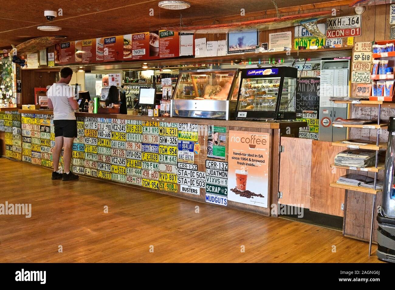 Pimba, SA, Australia - November 12, 2017: Unidentified people inside Spud's roadhouse with lot of license plates, preferred stop for food and drink on Stock Photo
