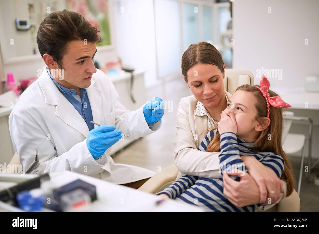 Child is scared of dentist. She don’t won’t to open mouth Stock Photo