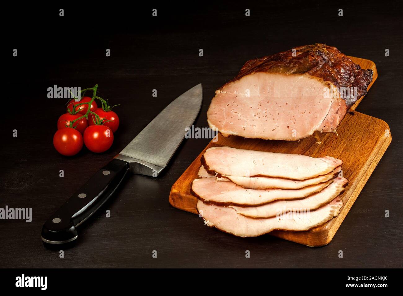 Smoked meat on a kitchen board. Homemade smoked pork with vegetables