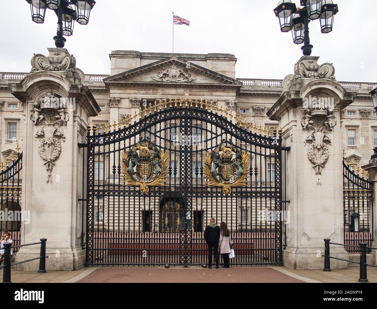 London, United Kingdom - October, 2018: Tourist in front of the Gates of Buckingham Palace the residence of British royal family in London Stock Photo
