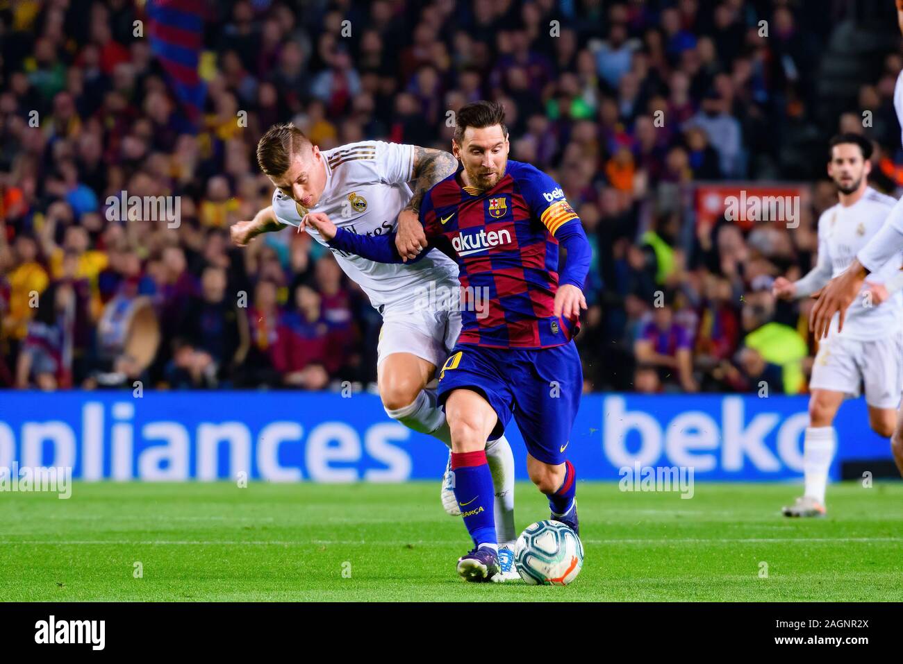 BARCELONA - DEC 18: Kroos (L) and Messi (R) play at the La Liga match between FC Barcelona and Real Madrid at the Camp Nou Stadium on December 18, 201 Stock Photo