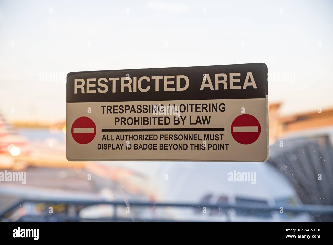 restricted area sign on exterior door in an airport with selective focus on the sign Stock Photo