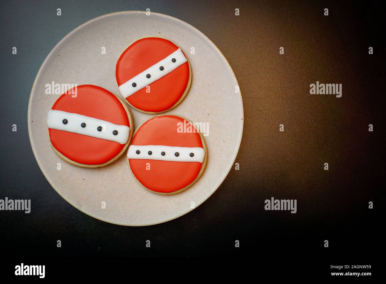 Top view of three round red cookies on a plate Stock Photo