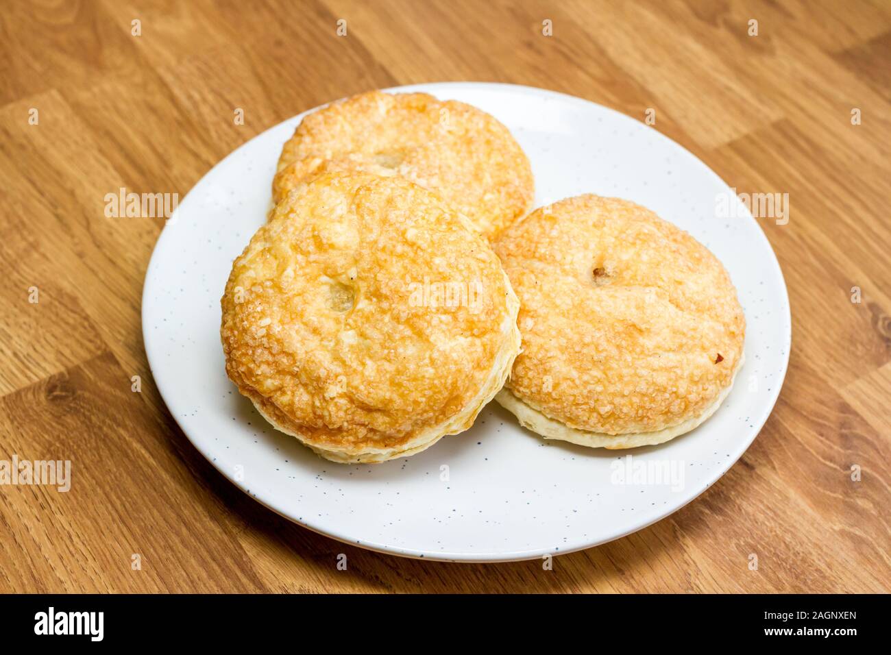 Puff pastry mince pies on a white plate Stock Photo