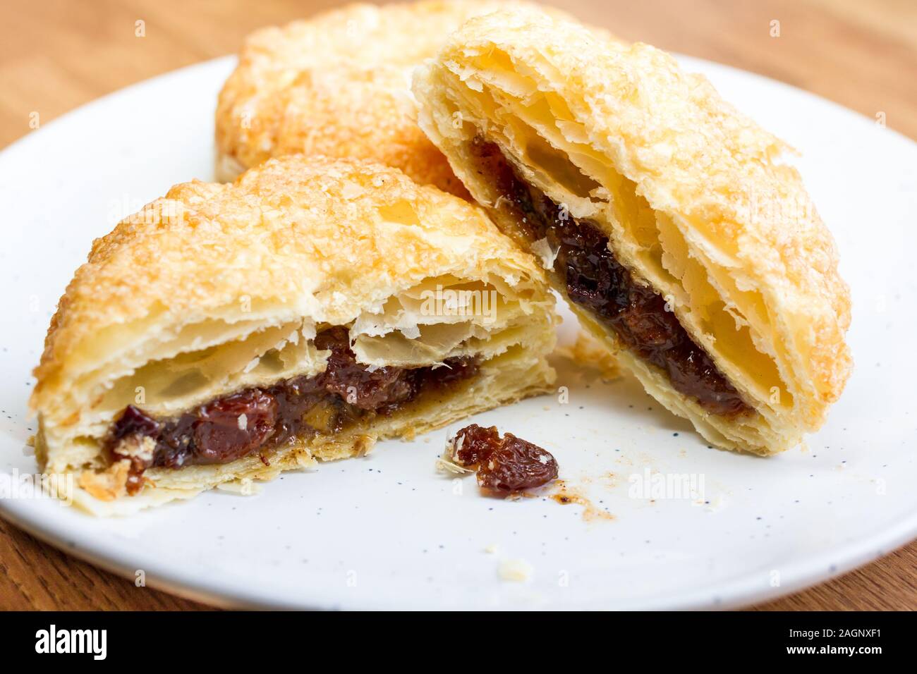 Puff pastry mince pies on a white plate Stock Photo