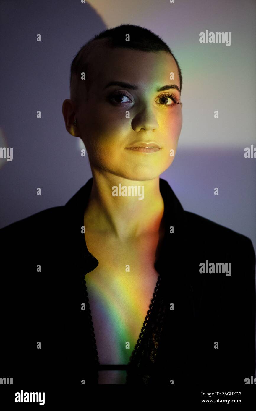 Close-up portrait of young bald woman in creative light. Stock Photo