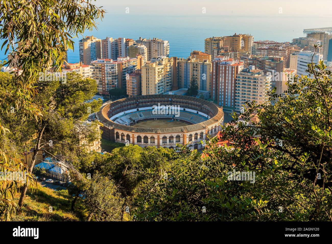 View of the bullring on the Spanish coast in Malaga. In the middle between high-rise buildings with a view over the roofs of Malaga with sunshine Stock Photo